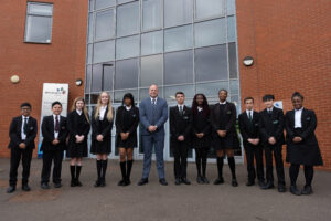 Wilmington Academy students and Principal, Mike Gore stood outside an academy building