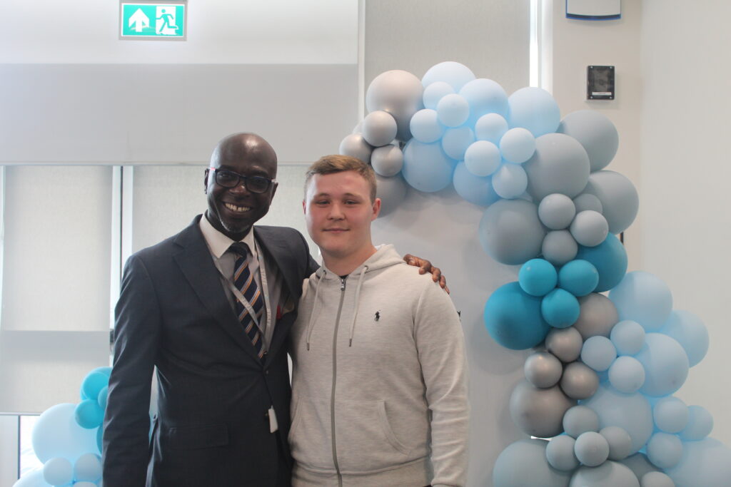 Student stood with Principal Donkor