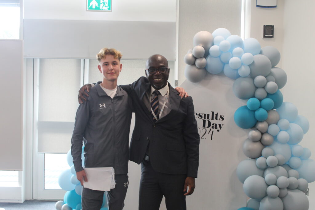 Student stood with Principal Donkor